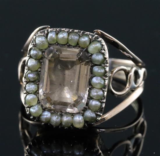A Georgian gold and foil backed paste and seed pearl set ring, size I/J.